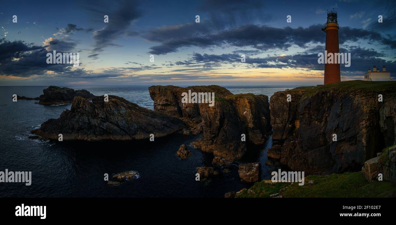 Panorama of Butt of Lewis lighthouse on high cliffs in sunset light, Scotland Stock Photo