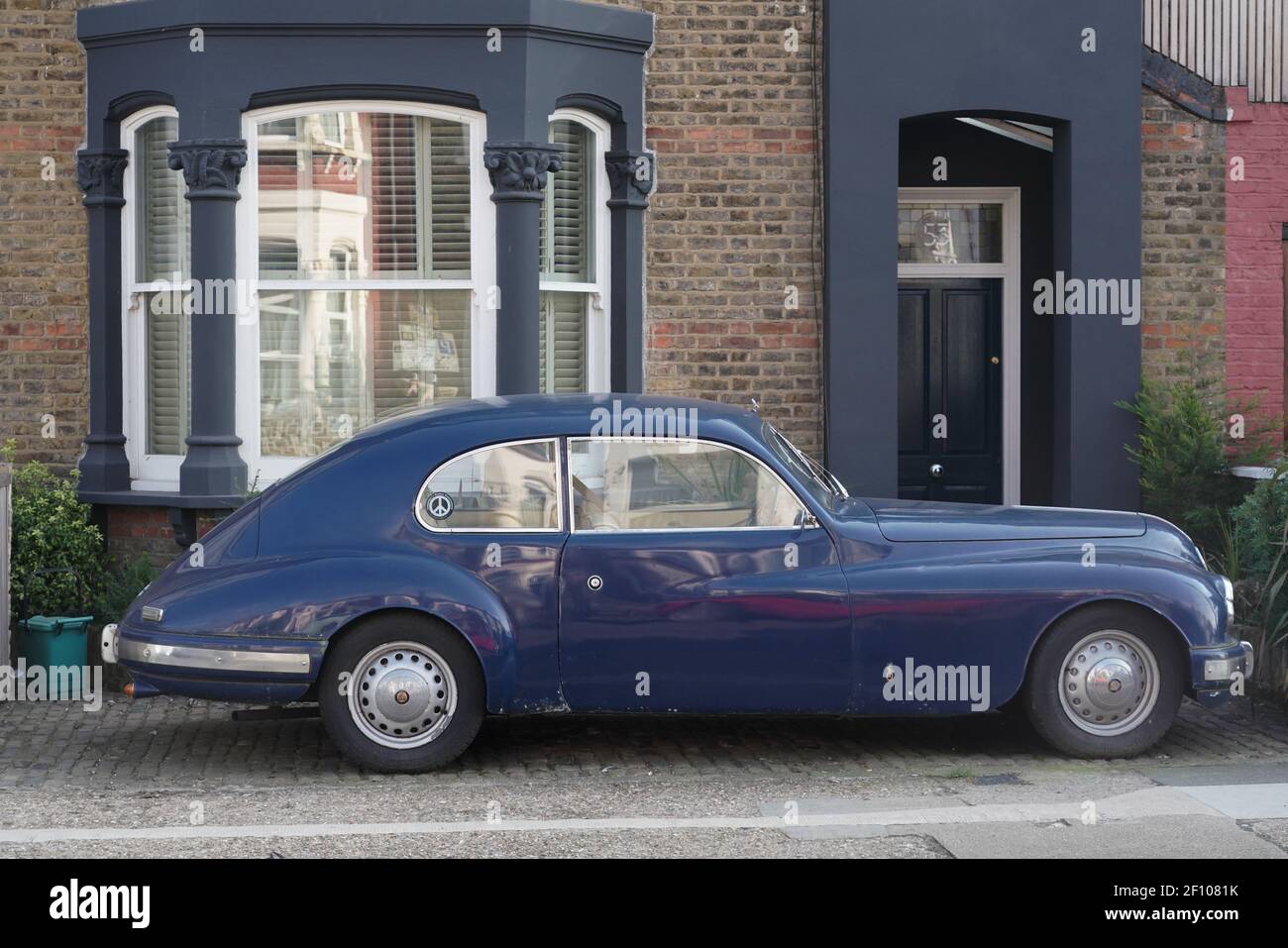 Classic car parked outside a house Stock Photo - Alamy