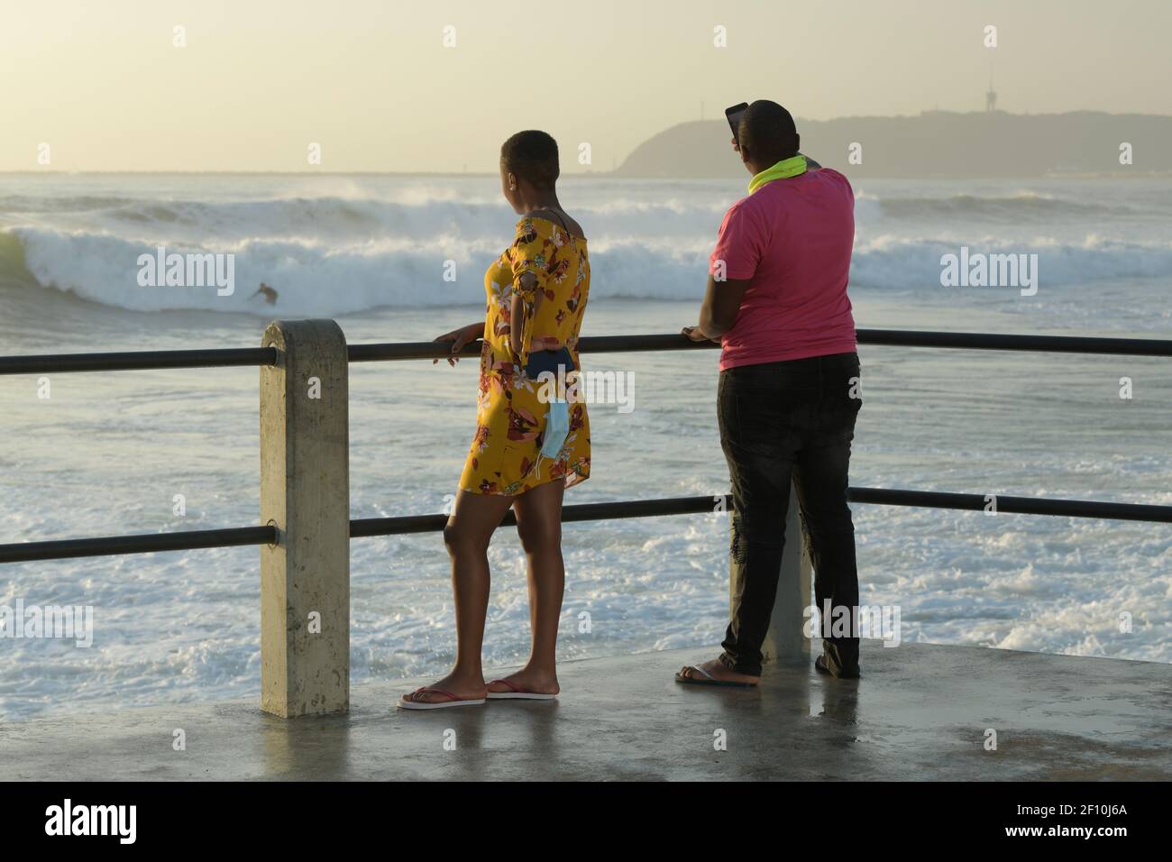 Adult couple, man, woman, standing on pier, looking at sea, ethnic, local tourist, Durban, South Africa, seaside holiday, beach vacation, partners Stock Photo