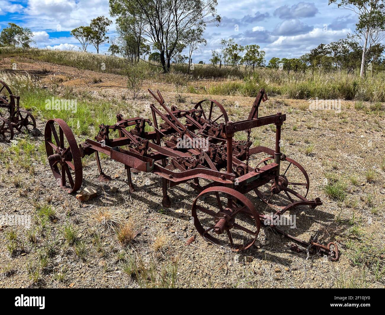 Old rusty farming equipment in the field of a farm in Queensland