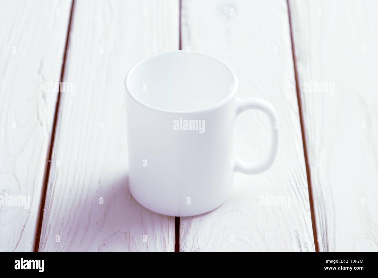 White cup mock-up on wooden table Stock Photo
