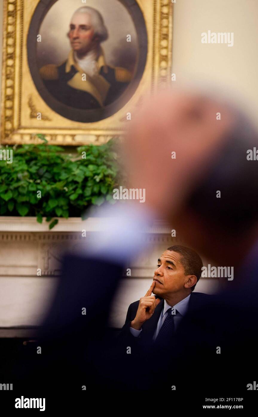 18 September 2009 - Washington, D.C. - President Barack Obama is framed by Rahm Emanuel's arm during a meeting with senior advisors in the Oval Office, Sept. 18, 2009. Photo Credit: Pete Souza / White House/Sipa Press/0910142032 Stock Photo