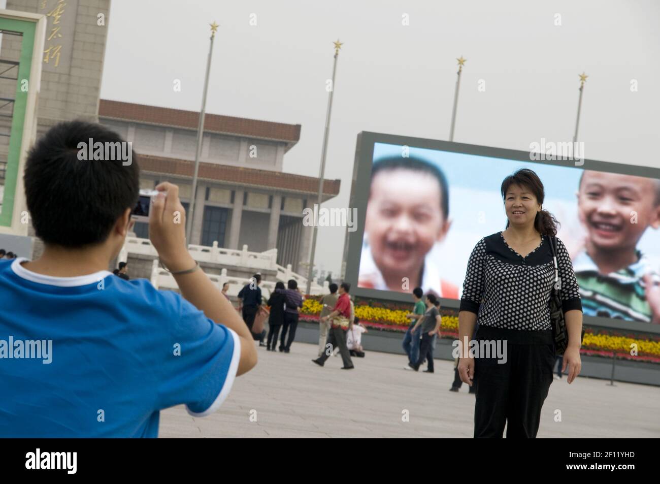 A woman is getting photographed on Tian An Men square. (Photo by Raphael Fournier/Sipa USA) Stock Photo
