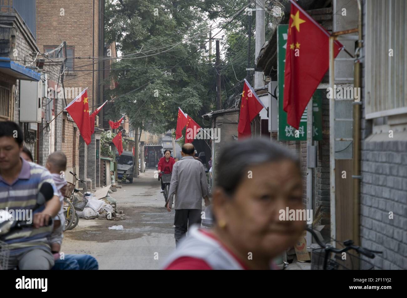 Chinese flags in a Beijing hutong (popular and historic area). (Photo by Raphael Fournier/Sipa USA) Stock Photo