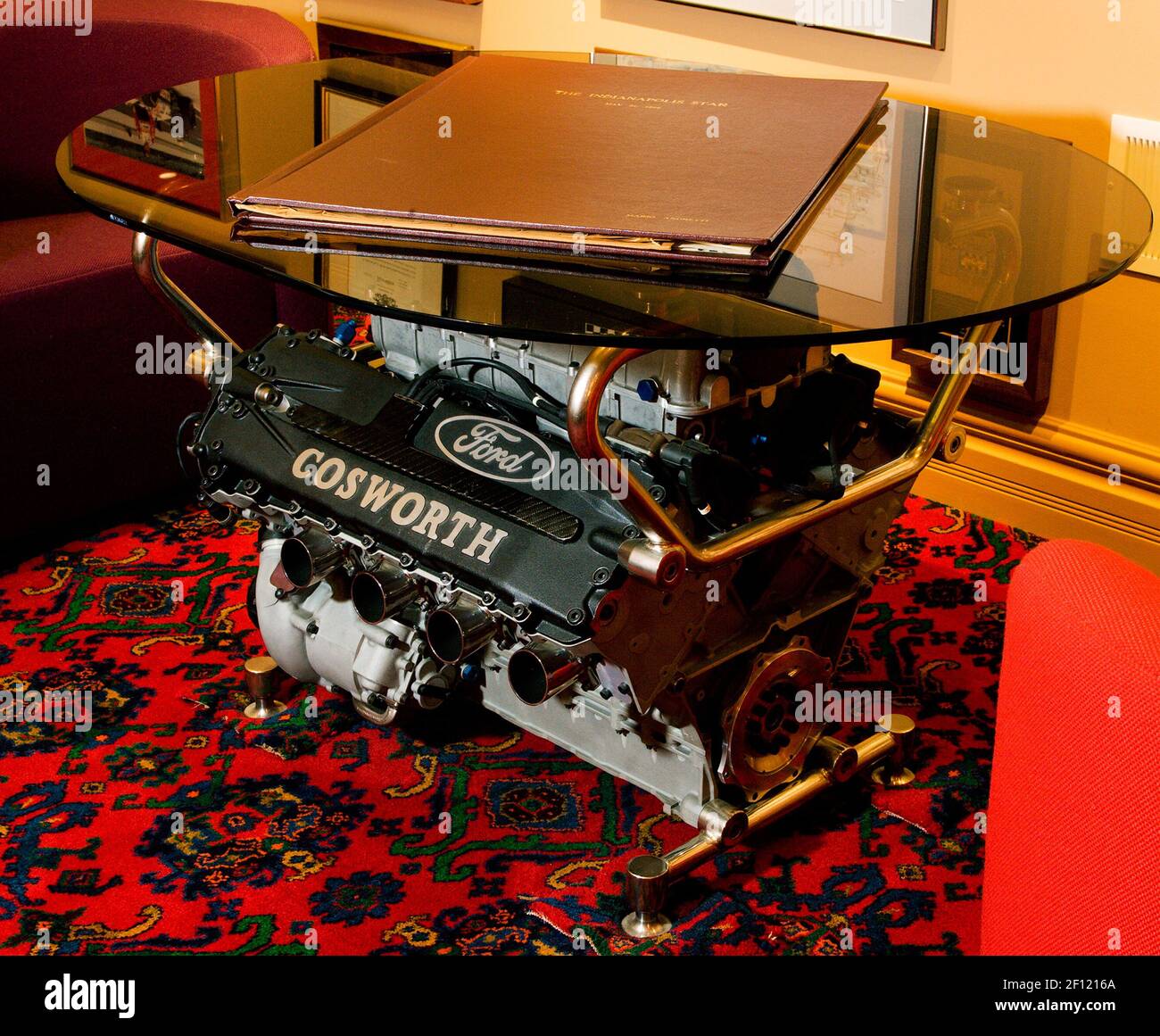 A Cosworth racing engine is the base of a coffee table in the "manspace