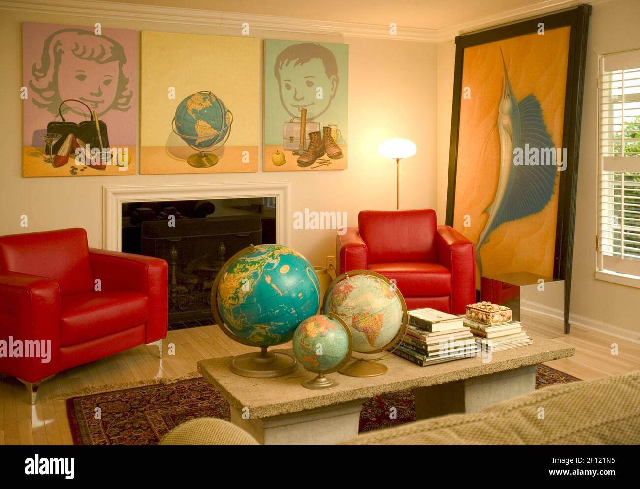 A grouping of three globes on a coffee table plays off the ...