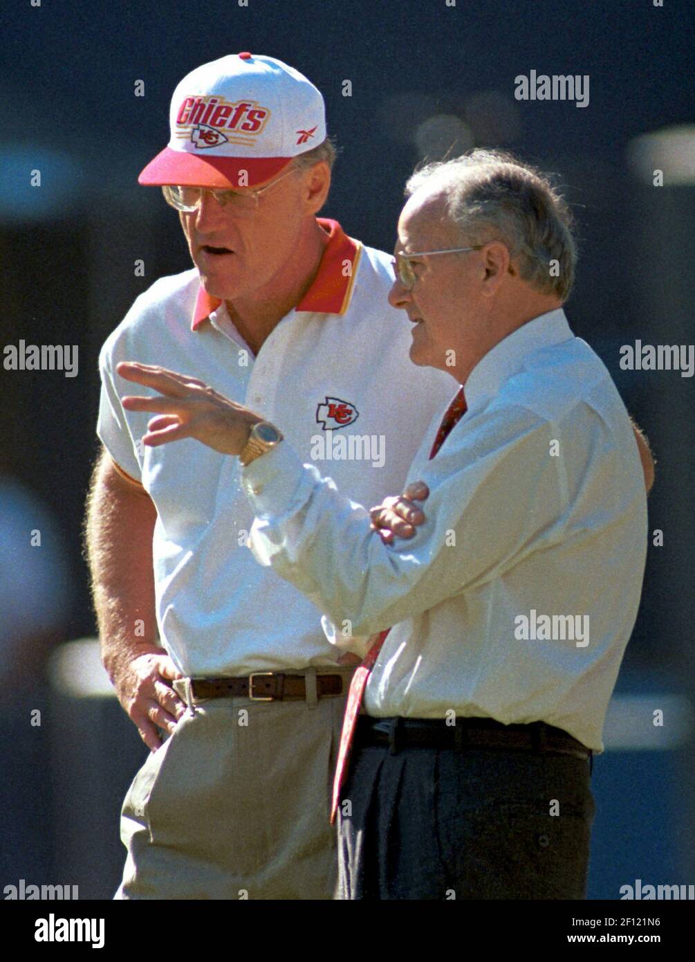 Kansas City Chiefs owner Lamar Hunt (right) talks with head football coach  Marty Schottenheimer before the start of the game against the San Diego  Chargers in 1998. Hunt died Wednesday in Dallas