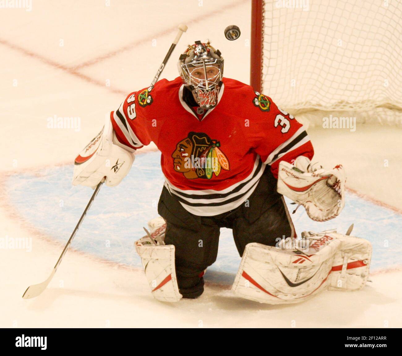 Chicago Blackhawks goaltender Nikolai Khabibulin clears ice from around the  goal after the St. Louis Blues score their third goal of the first period  at the Savvis Center in St. Louis on