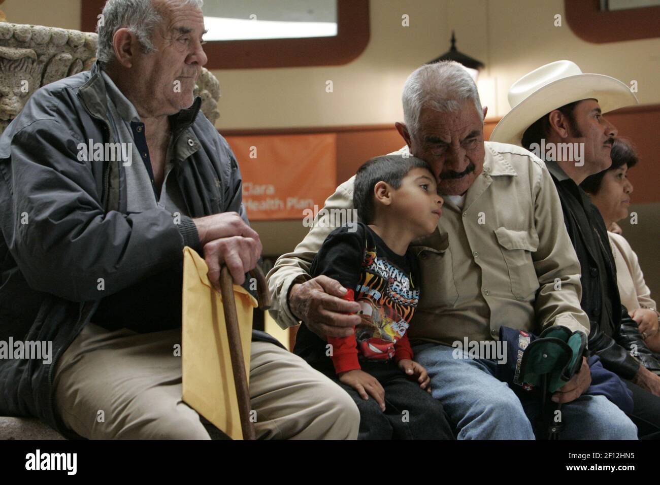 Miguel Padilla, 70, of San Jose, California, Jackson Bruno, 5, and  grandfather Salomon Brito, of Morgan Hill, attend a meeting of former  Braceros at Mi Pueblo Supermarket in San Jose. The group