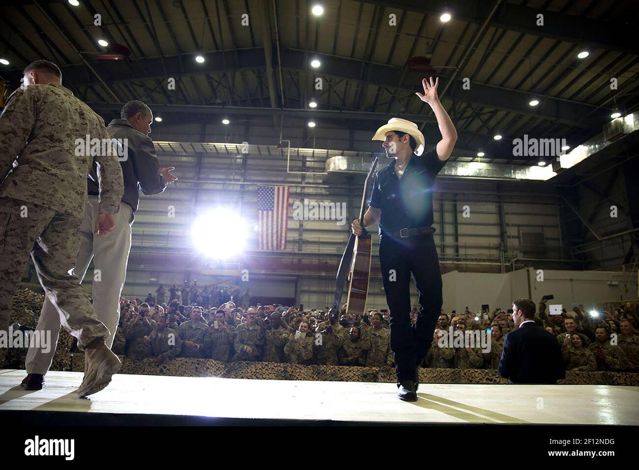 Country singer Brad Paisley leaves the stage as President Barack Obama and General Joseph Dunford, Jr arrive to address U.S. troops during a rally at Bagram Airfield, Afghanistan, Sunday, May 25, 2014. Stock Photo