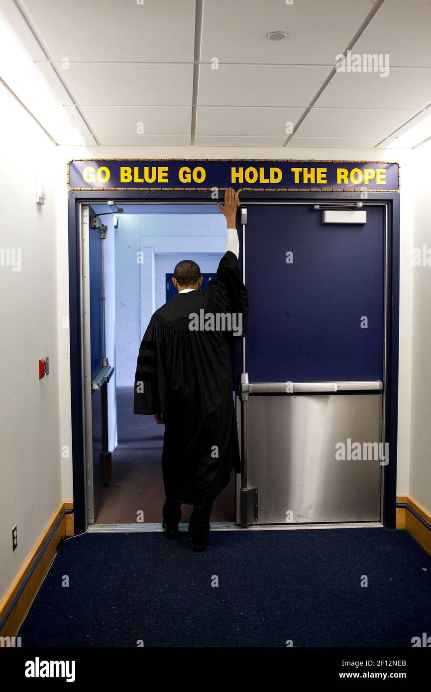 President Barack Obama touches the sign above the locker room door at Michigan Stadium, before giving the commencement address to University of Michigan graduates in Ann Arbor, Mich., May 1, 2010 Stock Photo