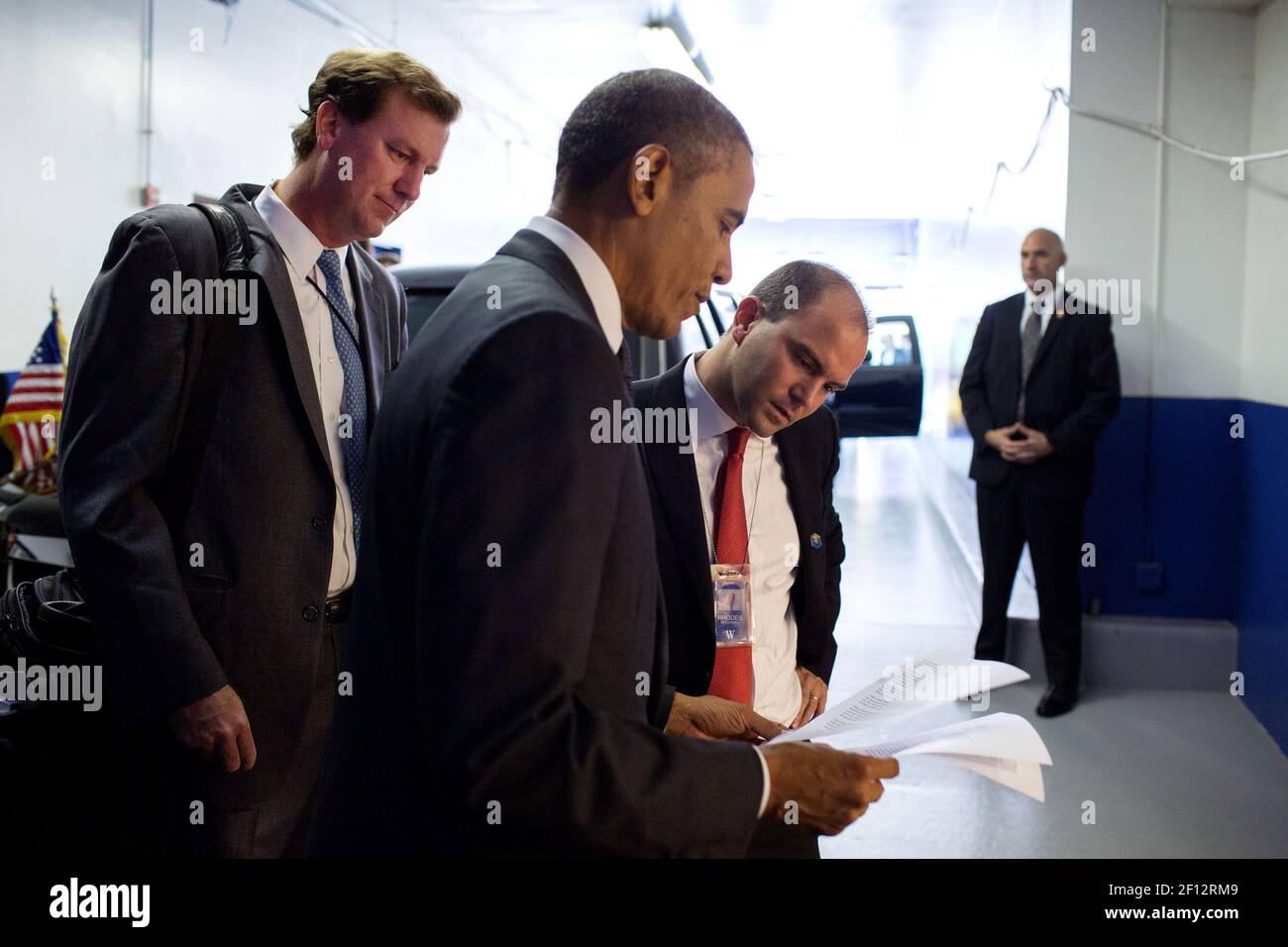 President Barack Obama confers with Trip Director Marvin Nicholson left and Ben Rhodes Deputy National Security Advisor for Strategic Communications as they stand by the motorcade prior to a Young African Leaders Initiative (YALI) town hall in Washington D.C. July 28 2014. Stock Photo