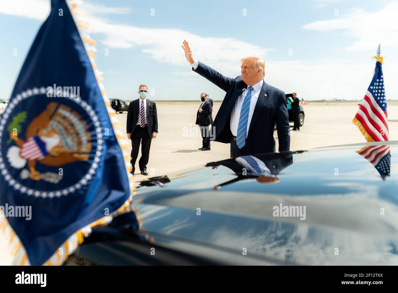 President Donald Trump waves and gestures to the crowd upon his arrival to Midland International Air and Space Port in Midland Texas Wednesday July 29 2020 where he was greeted by Texas Gov. Greg Abbott former Secretary of Energy Rick Perry Texas Lt.Gov. Dan Patrick Texas Republican Chairman Allen West U.S. Representative candidates and members of the community. Stock Photo