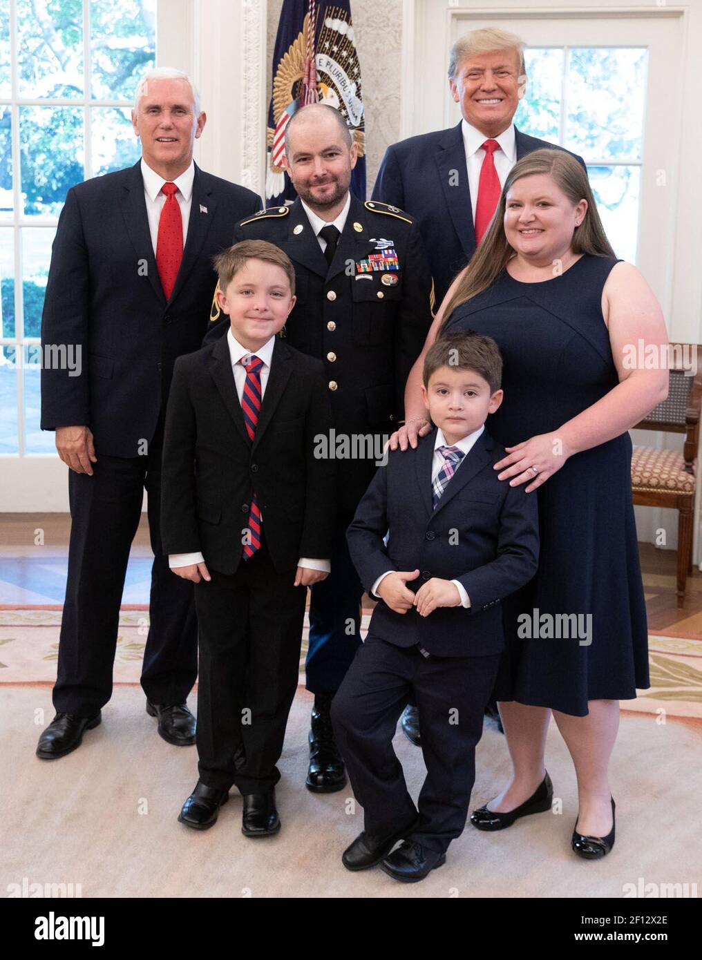 President Donald Trump and Vice President Mike Pence pose for a photo with Medal of Honor recipient retired U.S. Army Staff Sgt. Ronald J. Shurer II his wife Miranda and sons Monday Oct. 1 2018 in the Oval Office Stock Photo