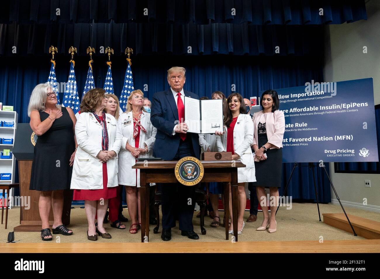 President Donald Trump is applauded as he displays his signature after signing Executive Orders on lowering drug prices Friday July 24 2020 in the South Court Auditorium in the Eisenhower Executive Office Building at the White House. Stock Photo