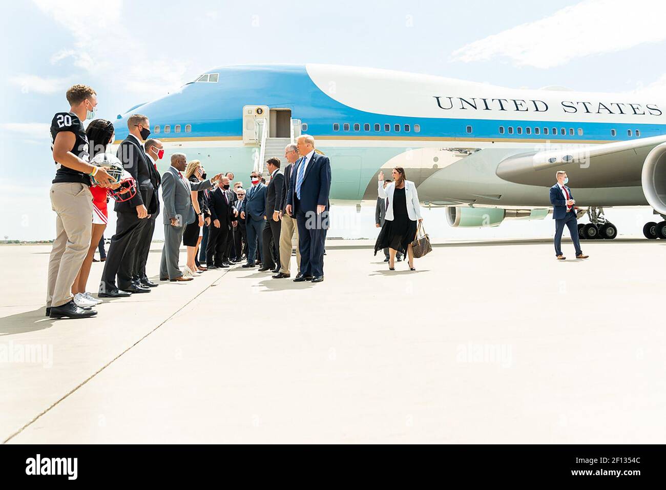 President Donald Trump disembarks Air Force One at Midland International Air and Space Port in Midland Texas Wednesday July 29 2020 and is greeted by Texas Gov. Greg Abbott former Secretary of Energy Rick Perry Texas Lt.Gov. Dan Patrick Texas Republican Chairman Allen West U.S. Representative candidates and members of the community. Stock Photo