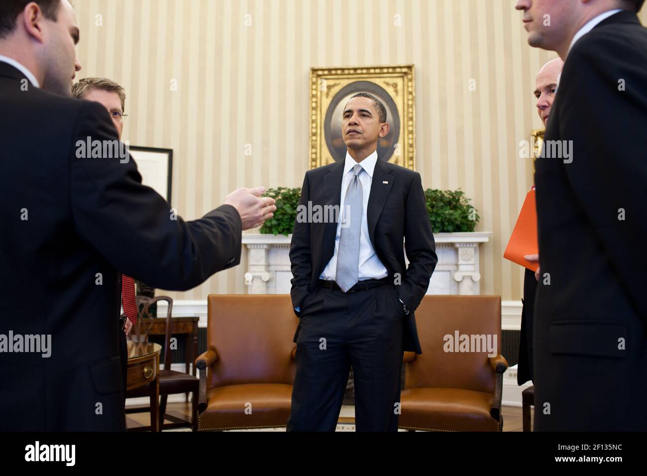 President Barack Obama talks with senior advisors following a meeting in the Oval Office March 3 2011. Fom left: Deputy National Security Advisor for Strategic Communication Ben Rhodes; Press Secretary Jay Carney; National Security Advisor Tom Donilon; and Dan Restrepo Senior Director for Western Hemisphere Affairs. Stock Photo