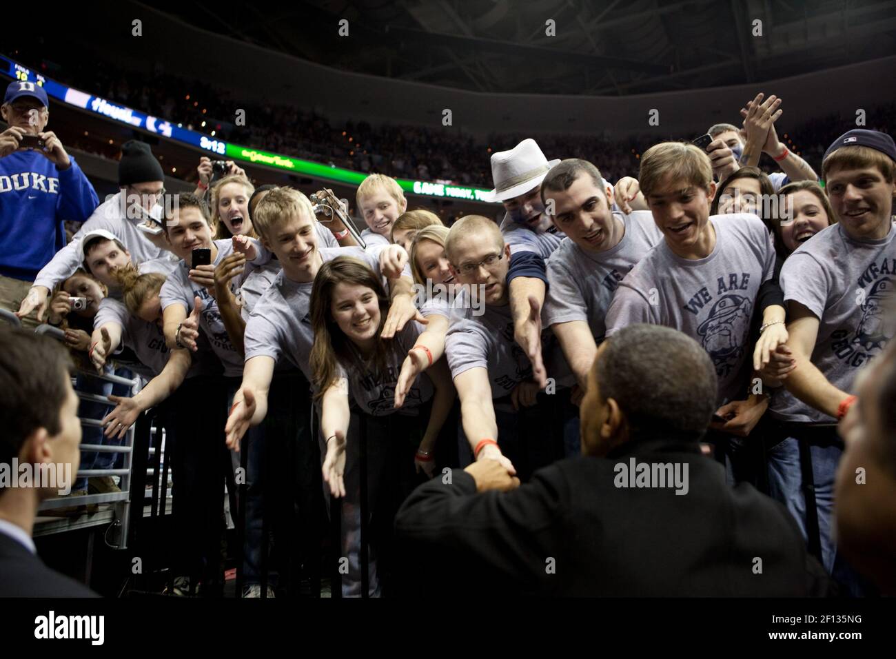 President Barack Obama shakes hands with fans at the Georgetown-Duke college basketball game at the Verizon Center in Washington D.C. Jan. 30 2010. Stock Photo