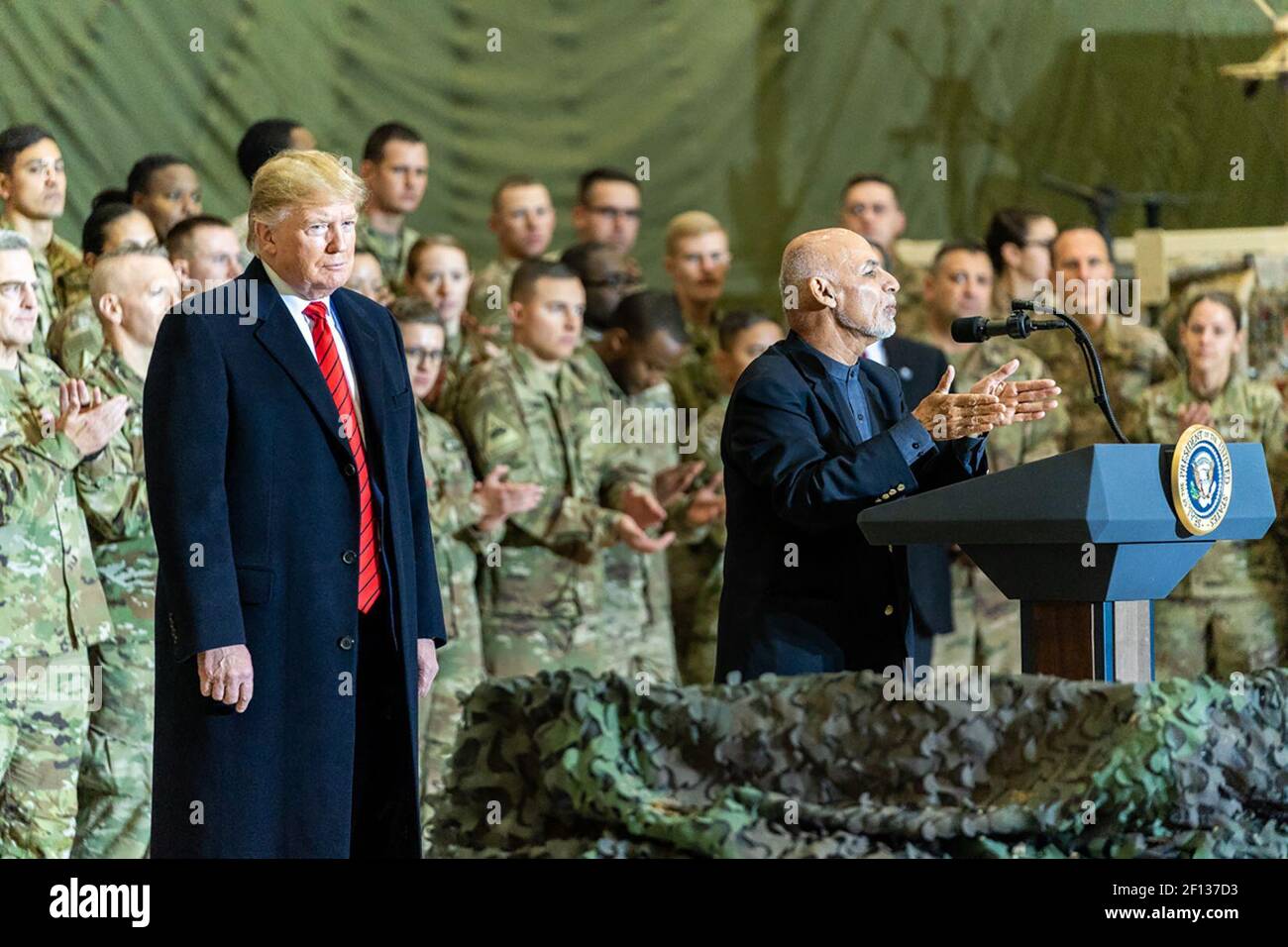 President Donald Trump listens as Afghan President Ashraf Ghani speaks to US military during a surprise Thanksgiving visit Thursday November 28 2019 at Bagram Airfield Afghanistan Stock Photo