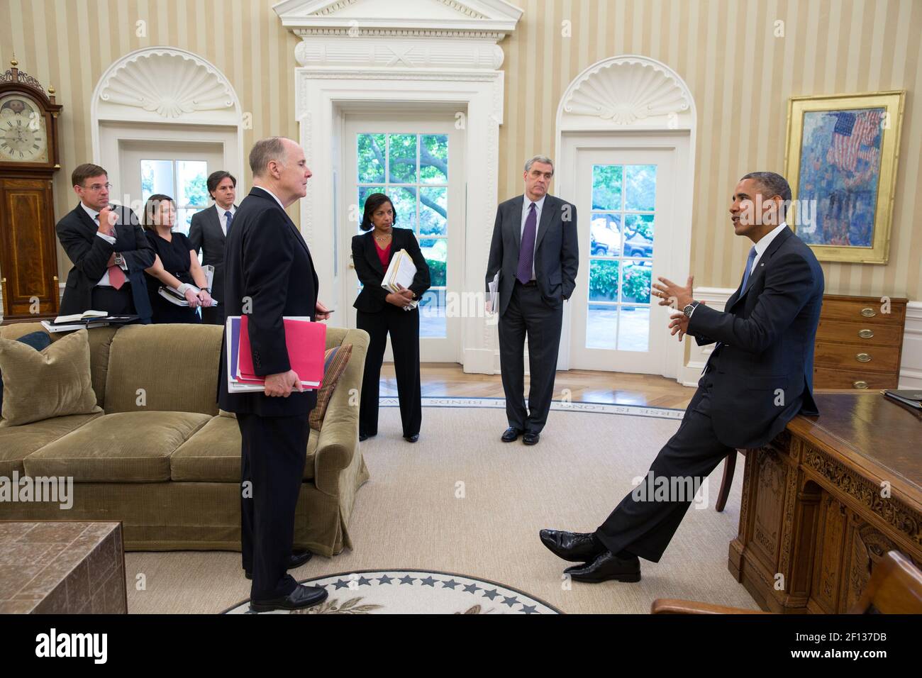 President Barack Obama talks with advisors in the Oval Office June 25 2013. Pictured from left are: Jeff Eggers Senior Director for Afghanistan and Pakistan; Lisa Monaco Assistant to the President for Homeland Security and Counterterrorism; Tony Blinken Deputy National Security Advisor; National Security Advisor Tom Donilon; Amb. Susan Rice the incoming National Security Advisor; and Doug Lute Deputy Assistant to the President and Coordinator for South Asia. Stock Photo