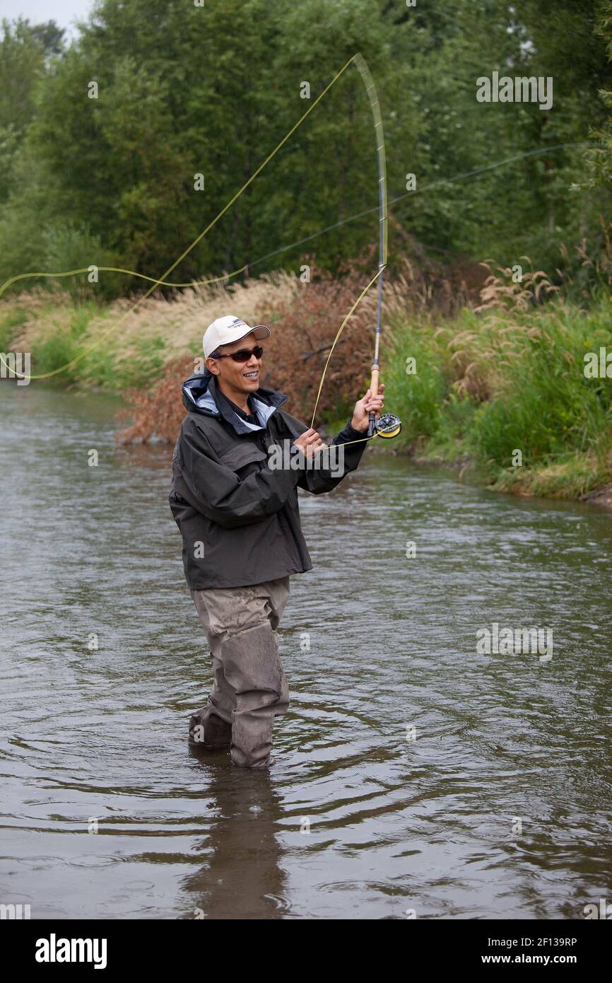 President Barack Obama casts his line while fishing for trout on the East Gallatin River near Belgrade Mont. August 14 2009.  The President hooked about 6 fish but did not land any during his first fly fishing outing. Stock Photo
