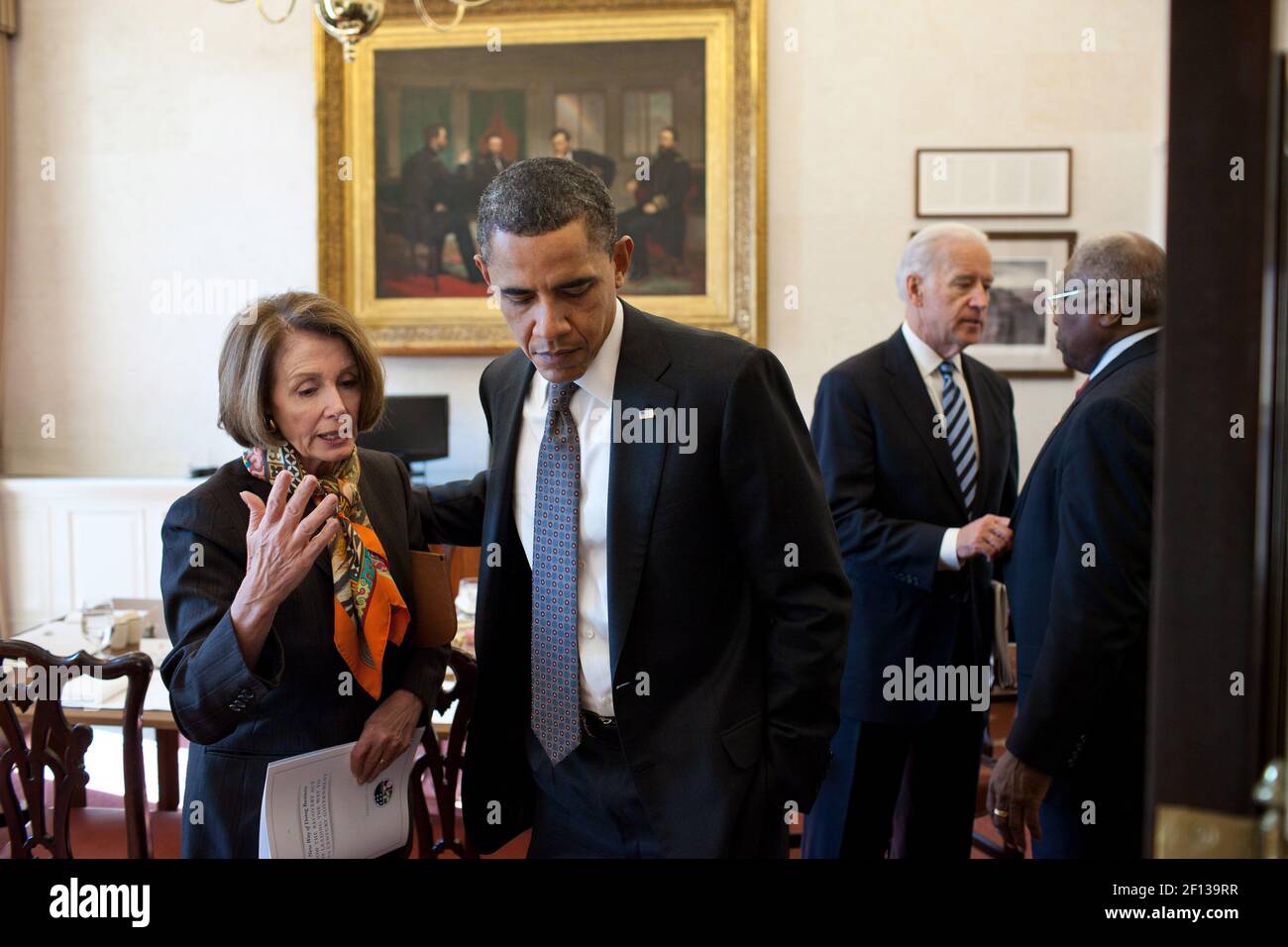 President Barack Obama talks with House Minority Leader Nancy Pelosi D-Calif. as Vice President Joe Biden talks with Rep. James Clyburn D-S.C. after a lunch with the Democratic House leadership in the Oval Office Private Dining Room Feb. 17 2011. Stock Photo