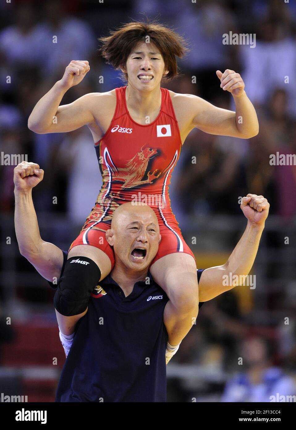 Saori Yoshida of Japan is hoisted on the shoulder of her