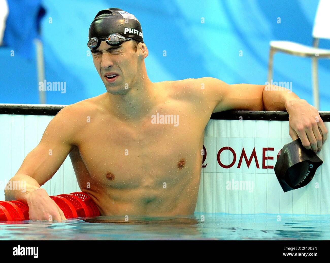 Michael Phelps of the United States rests in the pool after winning the