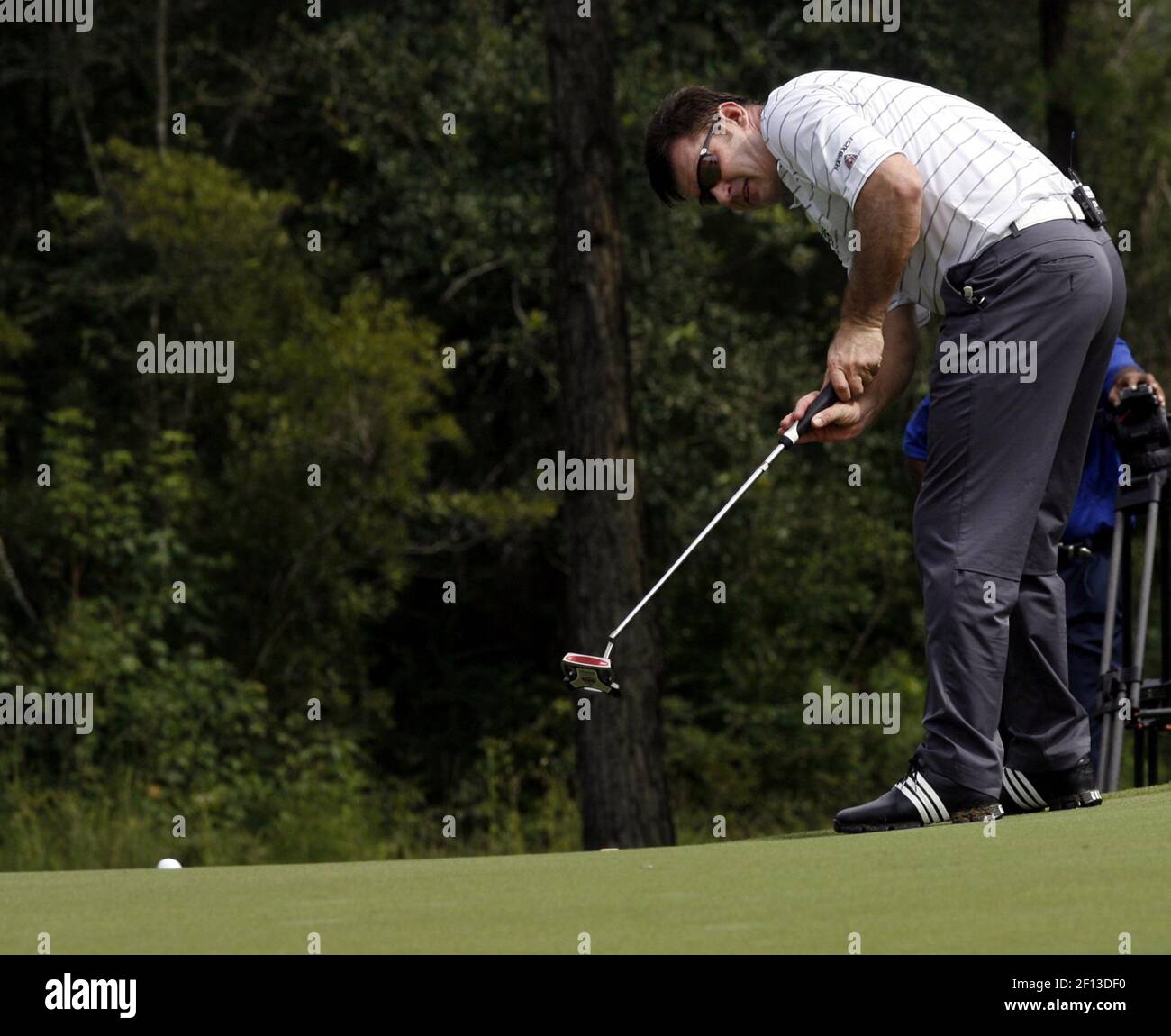 Nick Faldo watches his putt during a challenge game against Paul
