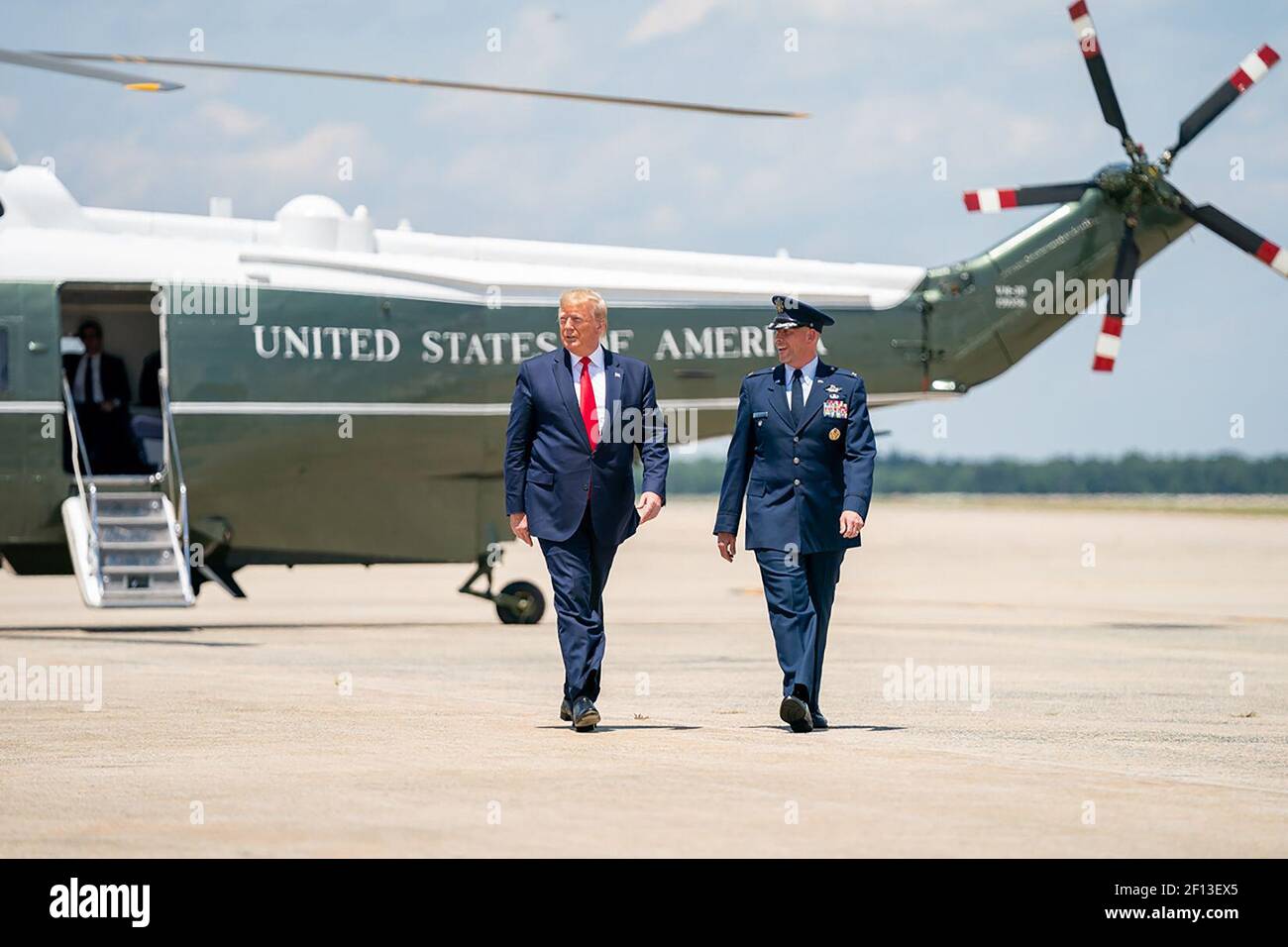 President Donald Trump disembarks Marine One and is escorted by Col. Samuel J. Chesnut vice-commander of the 89th Airlift Wing at Joint Base Andrews Md. Wednesday June 26 2019 as they walk from Marine One to board Air Force One for his trip to Japan. Stock Photo