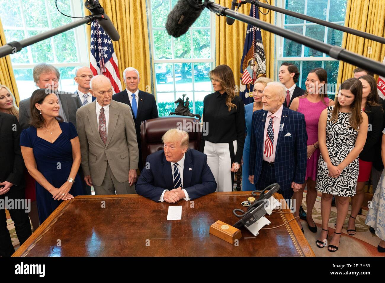 President Donald Trump joined by First Lady Melania Trump and Vice President Mike Pence speaks to reporters during a commemorative photo opportunity with Apollo 11 astronauts Buzz Aldrin and Michael Collins their family members and the family of Neil Armstrong Friday July 19 2019 during a celebration of the 50th anniversary of the Apollo 11 moon landing in the Oval Office of the White House. Stock Photo