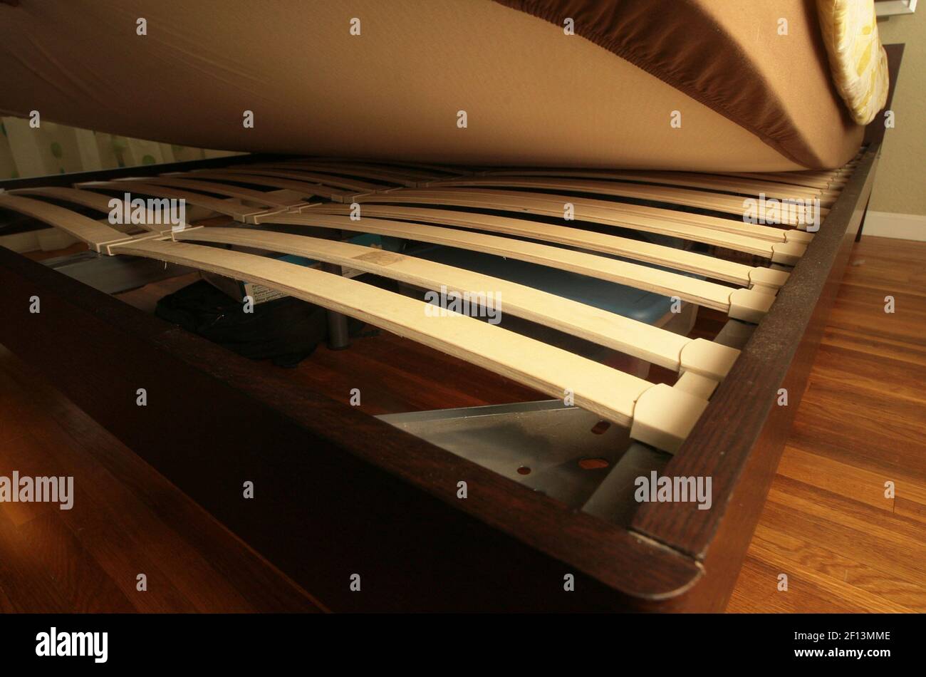 Bowed wooden slats provide support for a platform bed in the Andrew