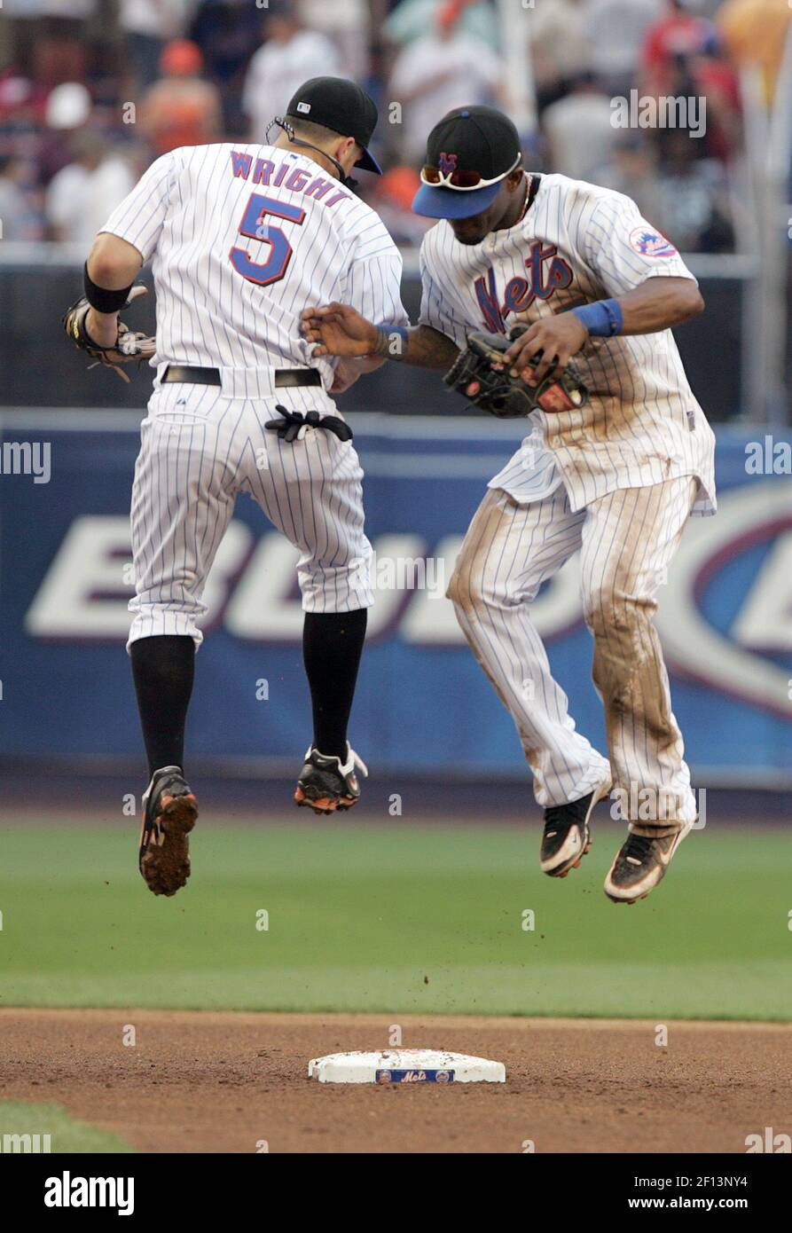 New York Mets David Wright and Jose Reyes leap in the air together