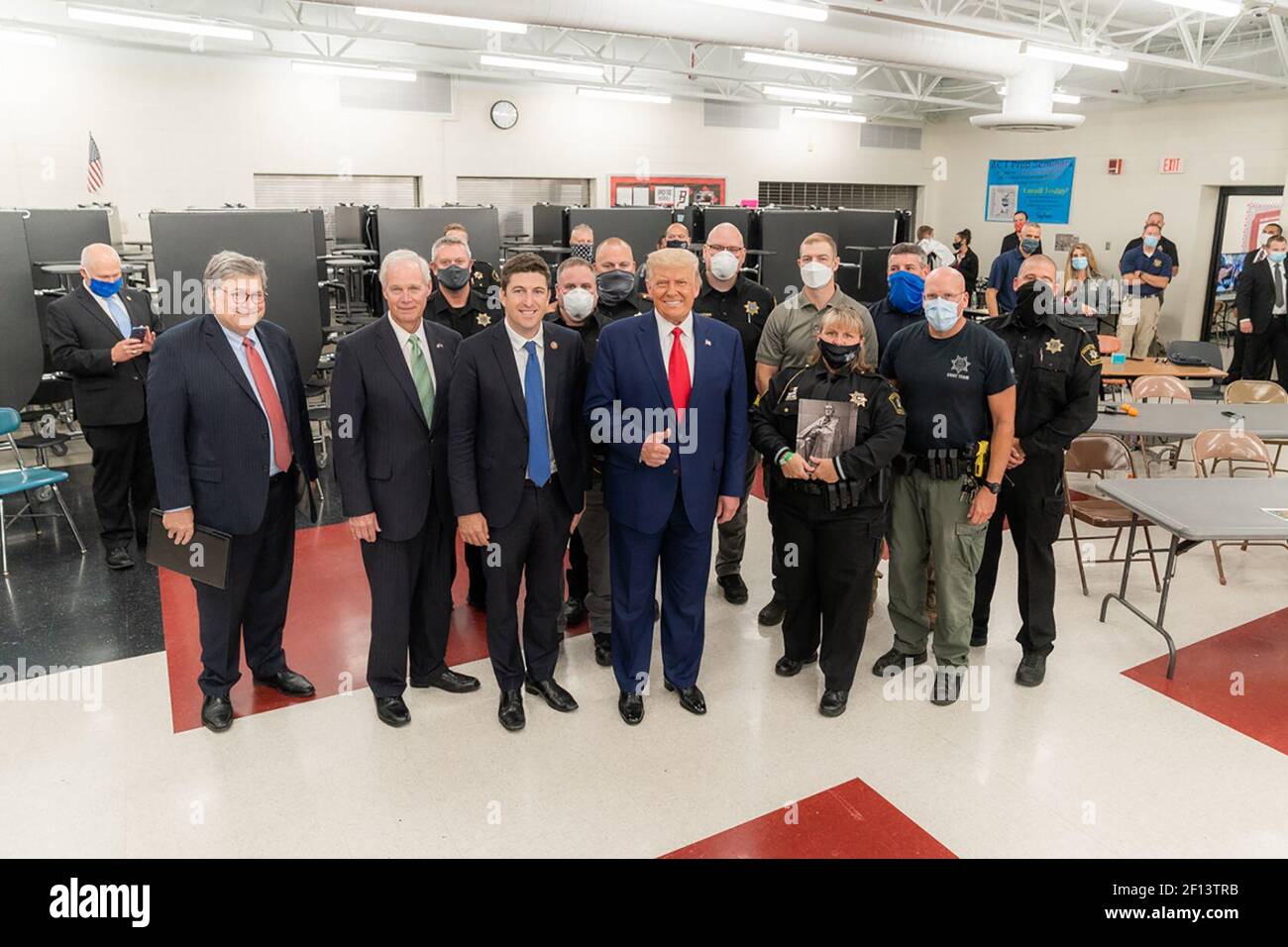 President Donald Trump is joined by U.S. Attorney William Barr left Rep. Bryan Steil R- Wis. Senator Ron Johnson. R-Wis and law enforcement officials as he concludes his tour at the emergency operation center Tuesday Sept. 1 2020 at Mary D. Bradford High School in Kenosha Wis. Stock Photo