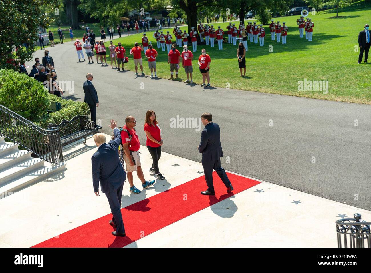 President Donald Trump seen with Veterans' Affairs Secretary Robert Wilkie waves as he concludes his welcome to Second Lady Karen Pence and U.S. Marine Terry Sharpe Monday July 27 2020 on the South Lawn of the White House. Mr. Sharpe walked form North Carolina to Washington D.C. to raise awareness of veteran suicides. Stock Photo