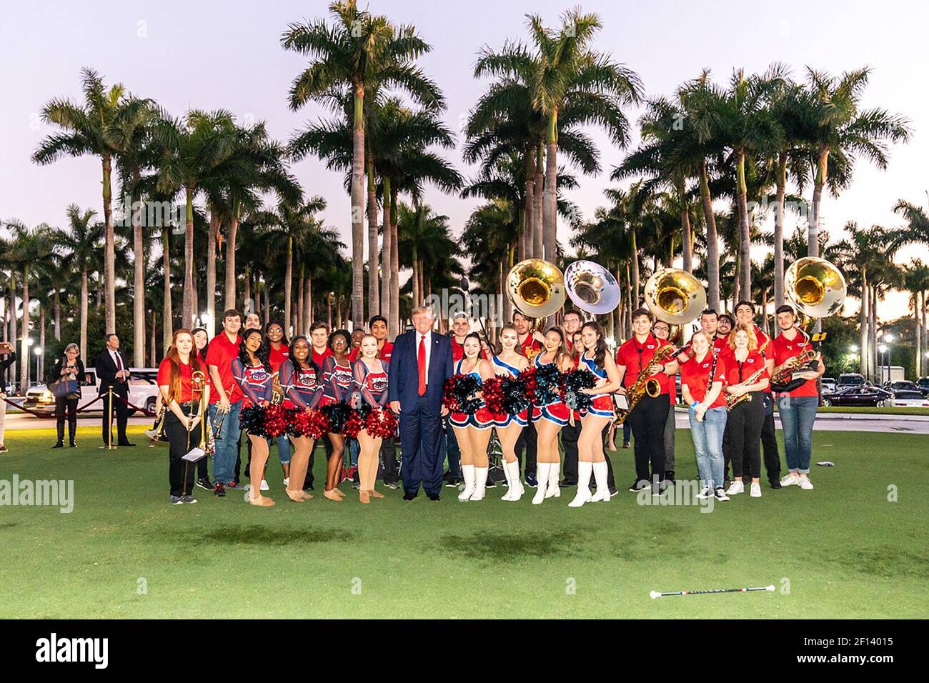 President Donald Trump poses for a photo with members of the Florida Atlantic University marching band Sunday evening Feb. 2 2020 outside the Trump International Golf Club in West Palm Beach Fla. prior to attending a Super Bowl party. Stock Photo