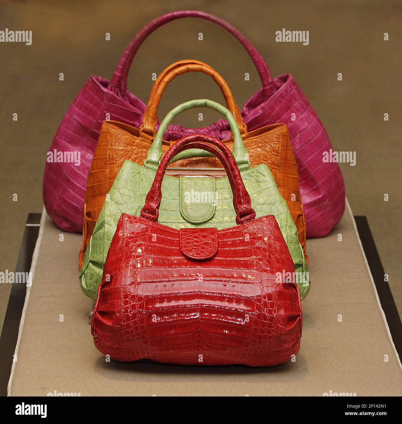 Nancy Gonzalez, from Colombia, shows off her latest collection of designer  handbags, like these handbags priced from bottom to top: red, $2750, green,  $2750, orange, $3325, pink, $3150, at Neiman Marcus in