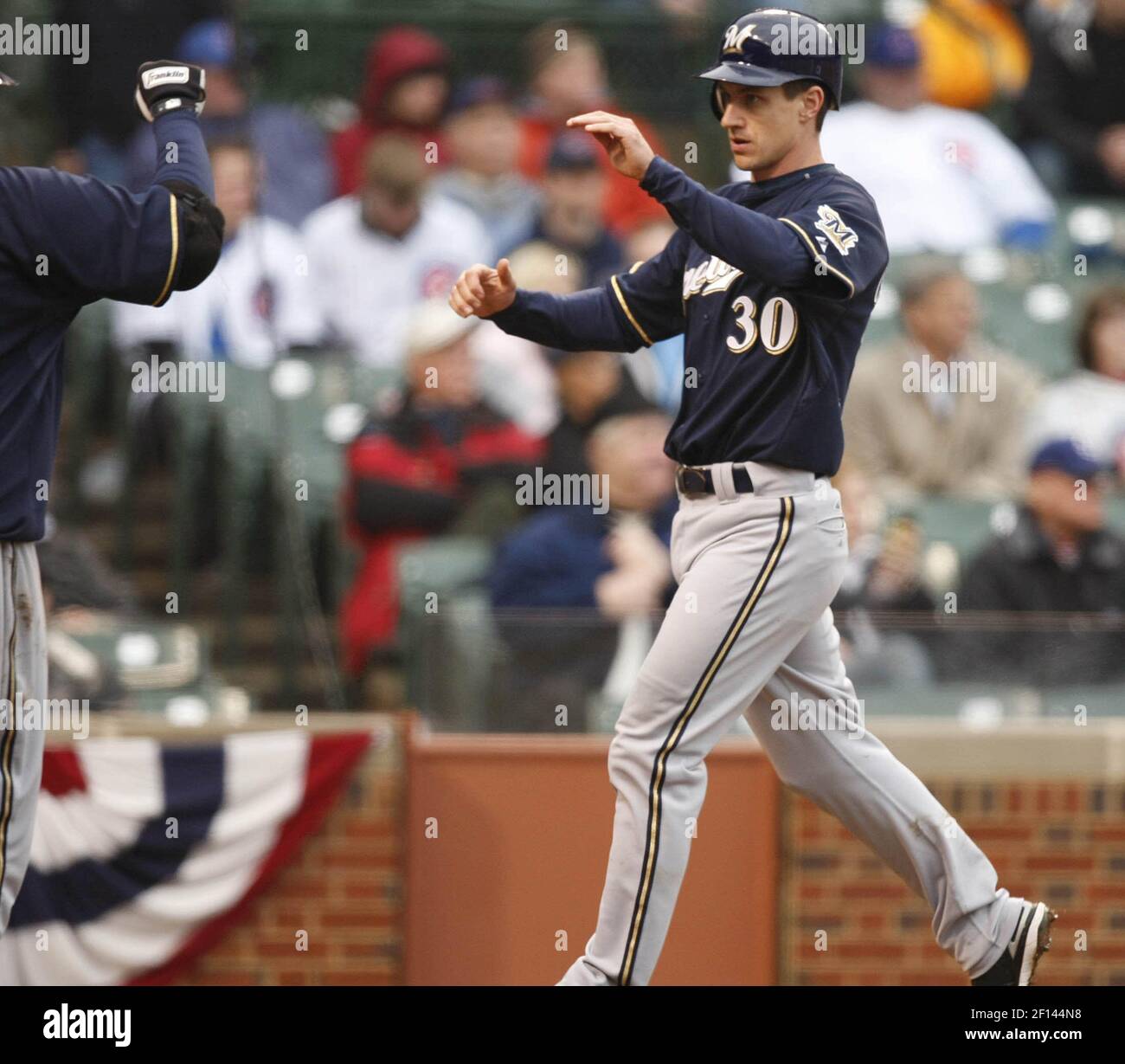 The Milwaukee Brewers' Craig Counsell (30) receives congratulations ...