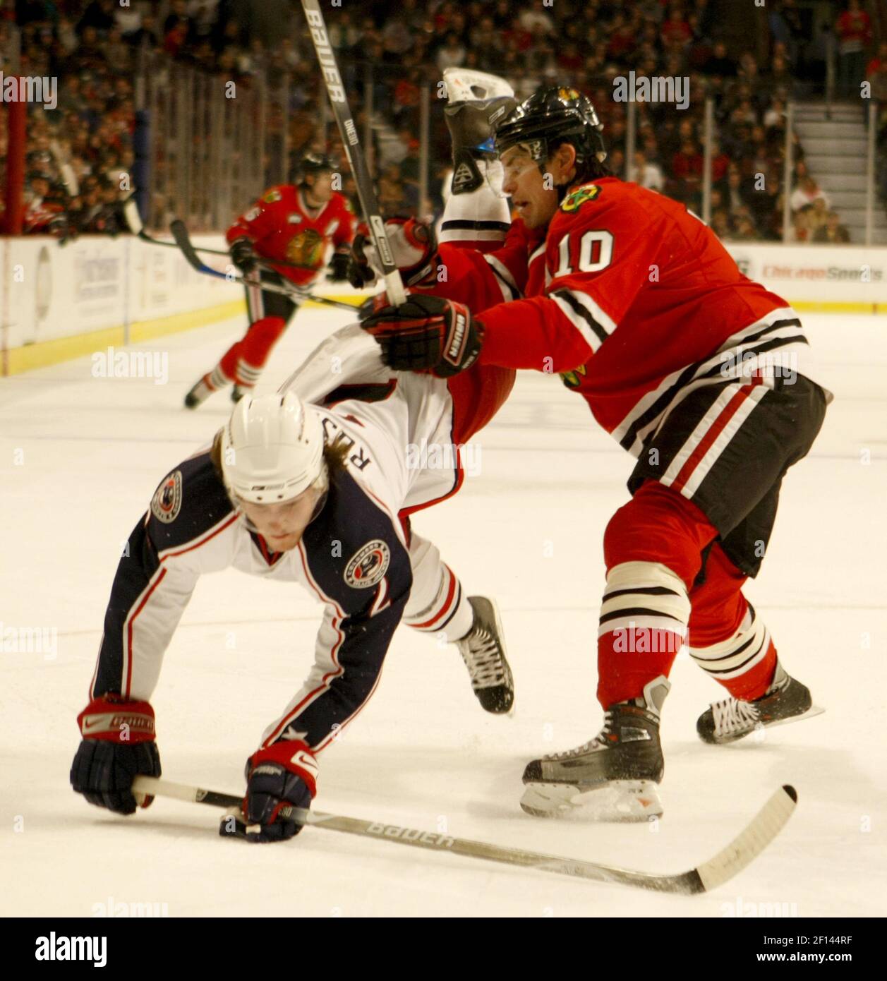 Chicago Blackhawks' Patrick Sharp checks Columbus Blue Jackets' Kris ...
