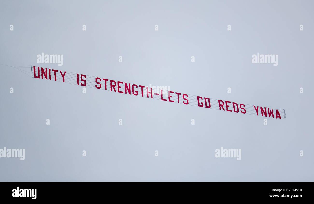 Liverpool. 7th Mar, 2021. A banner reads 'Unity Is Strength - Let's Go Reds YNWA' is flown over Anfield during the Premier League football match between Liverpool and Fulham at Anfield in Liverpool, Britain, on March 7, 2021. Credit: Xinhua/Alamy Live News Stock Photo