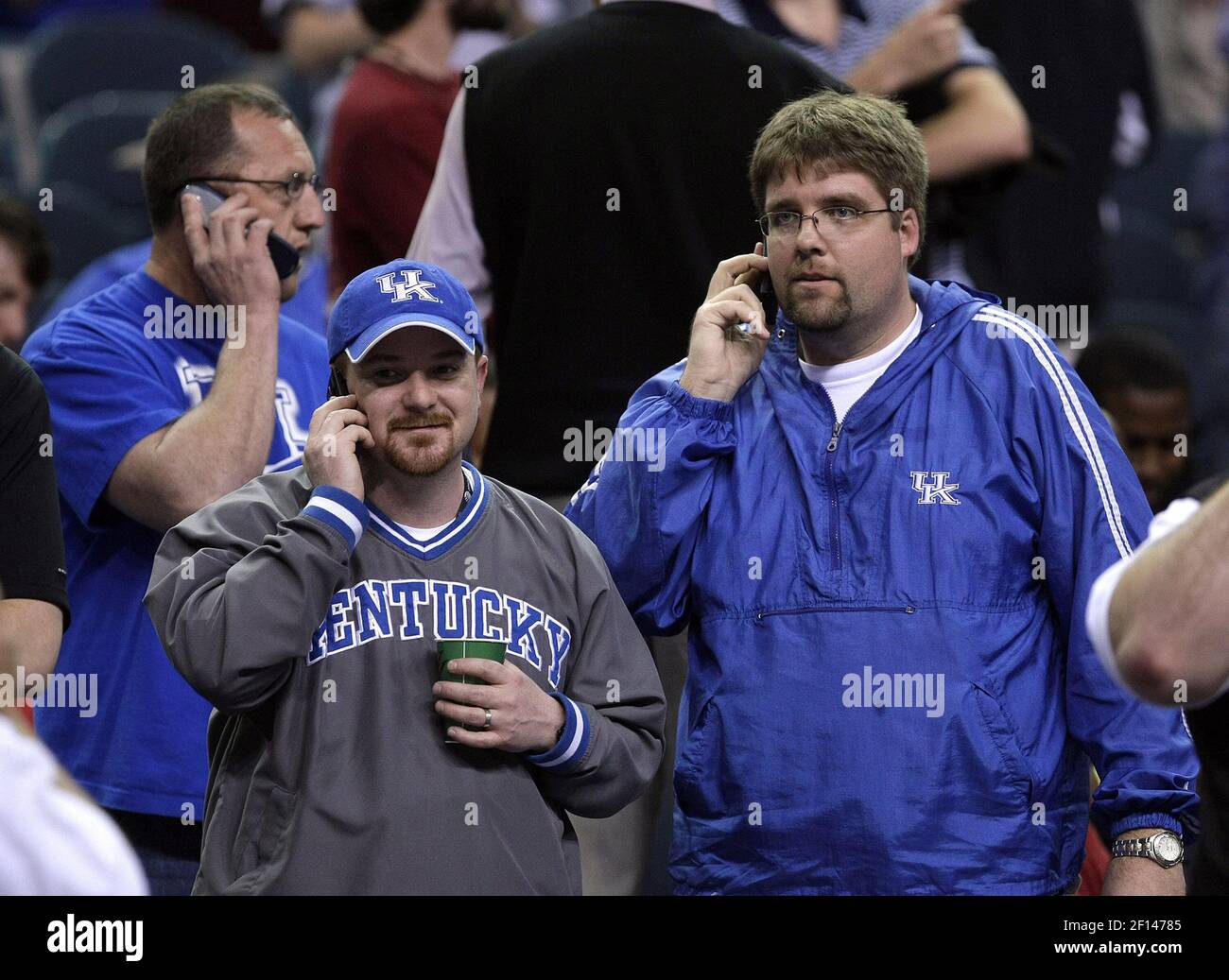 Kentucky fans (from left) D.R. Gray, of Eddieville, Heath Duncan, of Madisonville, and Tom Eveland of Madisonville call home to family after severe weather shook the Georgia Dome and postponed play in the SEC Tournament in Atlanta, Georgia, Friday March 14, 2008. (Photo by Mark Cornelison/Lexington Herald-Leader/MCT/Sipa USA) Stock Photo