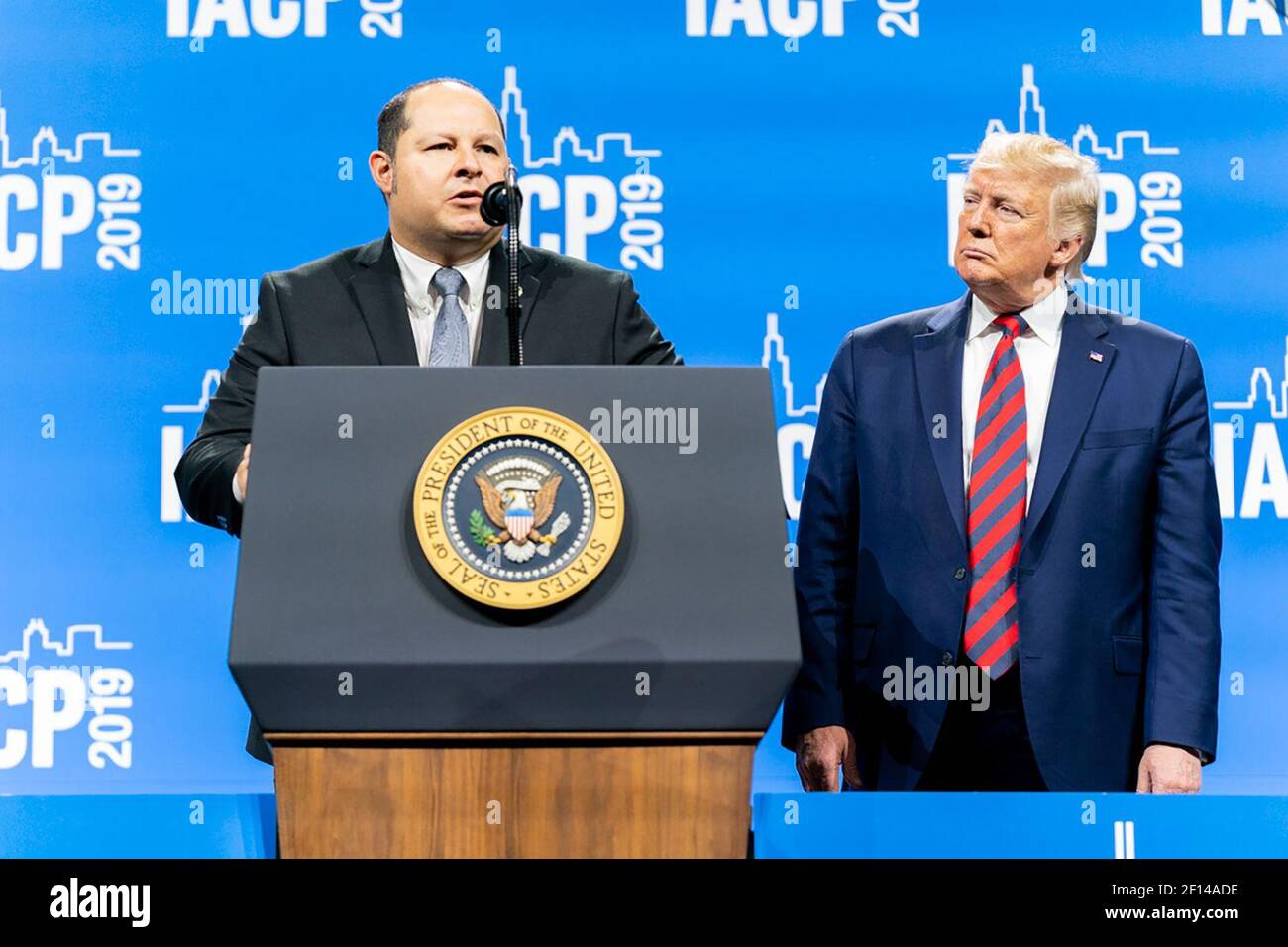 President Donald Trump listens as U.S. Customs and Border Patrol Agent Jonathon Morales delivers remarks Monday Oct. 28 2019 at the International Association of Chiefs of Police Annual Conference and Exposition at the McCormick Place Convention Center in Chicago. Stock Photo