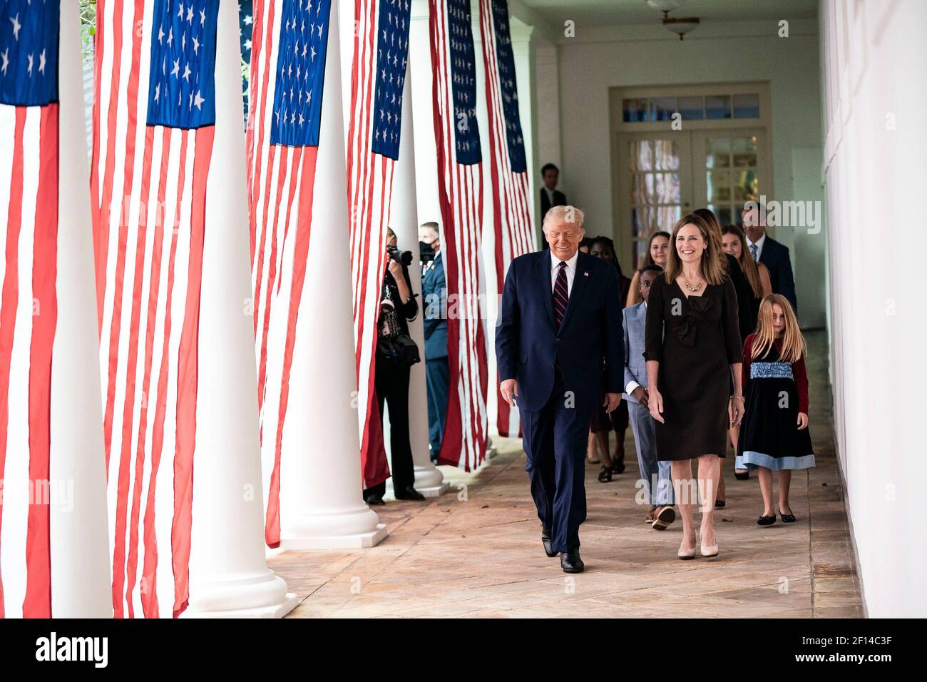 President Donald Trump walks with Judge Amy Coney Barrett his nominee for Associate Justice of the Supreme Court of the United States along the West Wing Colonnade on Saturday September 26 2020 following announcement ceremonies in the Rose Garden. Stock Photo