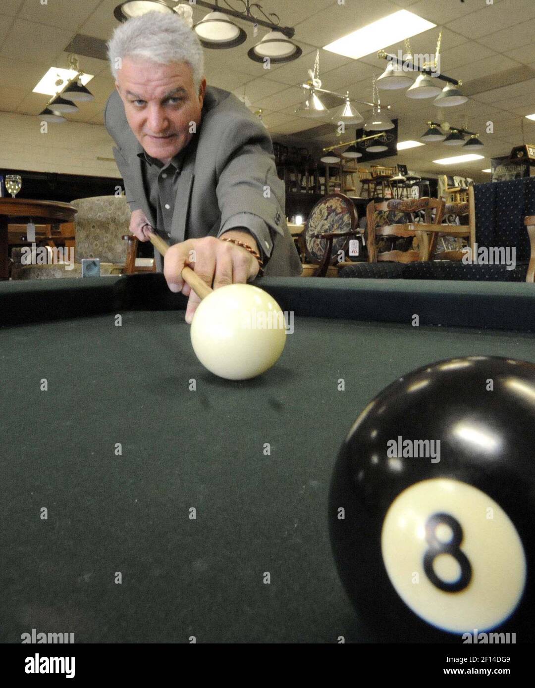 An 8000.00 Brunswick Gold Crown pool table sits for sale at Parvizi