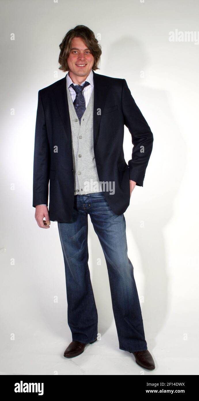 Jan Christian Andersen poses in the "after" shot. THE LOOK: Versace  Collection jacket ($645), Hugo by Hugo Boss cardigan ($165), Robert Talbott  tie ($125), Rock & Republic jeans ($240), Docal's boots ($350),