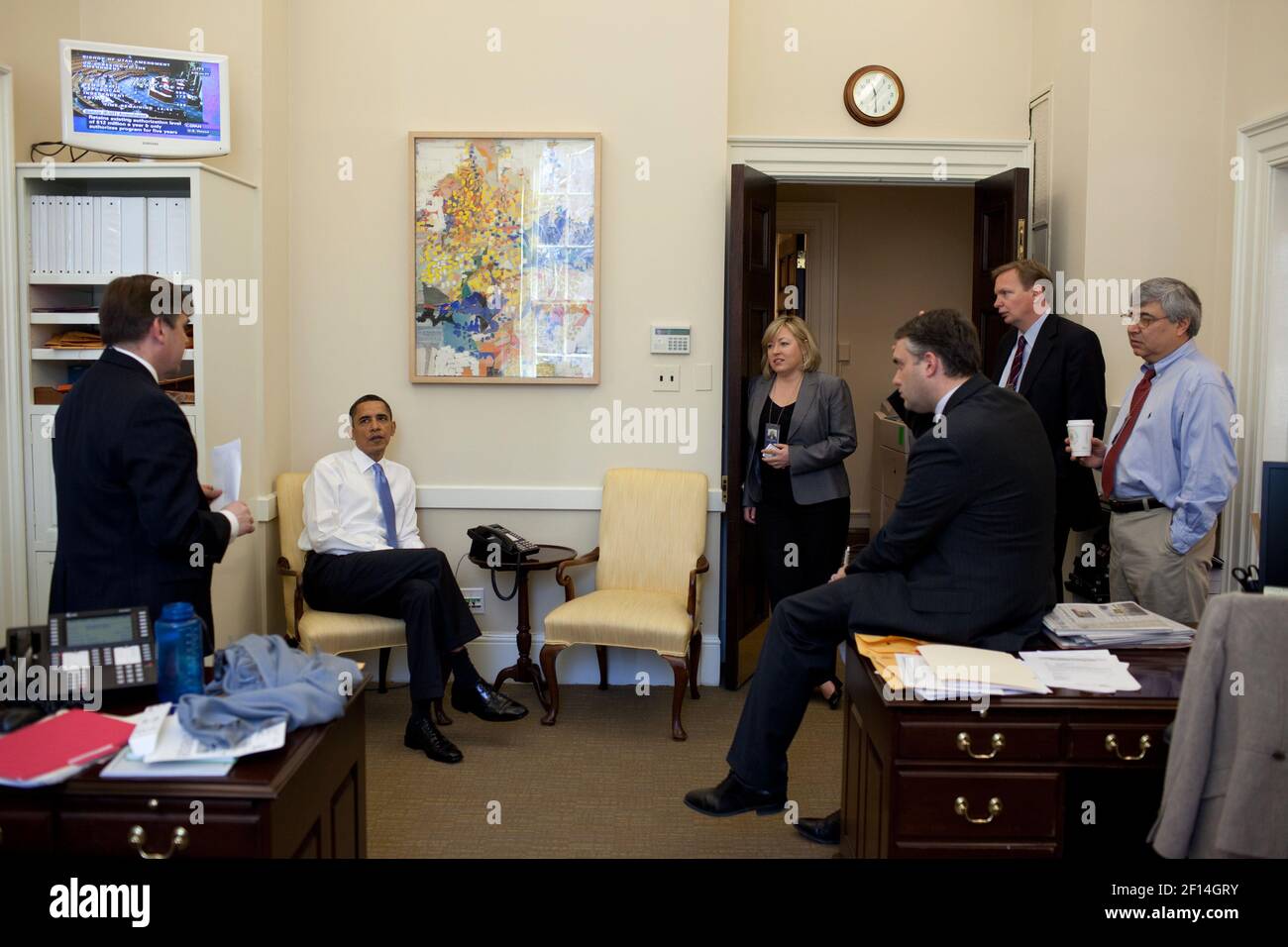 President Barack Obama listens to Dan Turton, deputy director of Legislative Affairs, during a health care strategy session with advisors in the Chief of Staff's Outer Office at the White House, March 20, 2010 Stock Photo