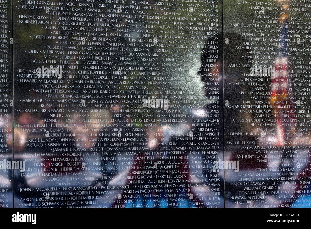 President Barack Obama is reflected in the Vietnam Veterans Memorial wall as he delivers remarks during the 50th Anniversary of the Vietnam War commemoration ceremony in Washington, D.C., May 28, 2012 Stock Photo