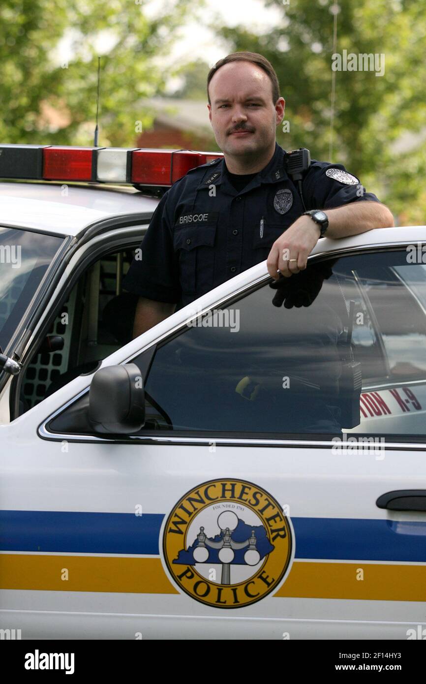 Winchester police officer Dennis Briscoe poses by his cruiser in