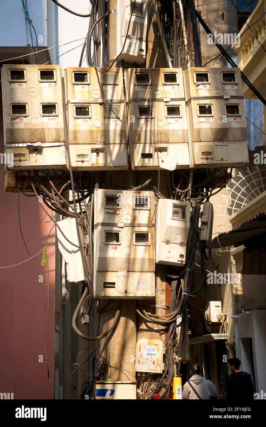 Tangled mess of electricity meter boxes and cables, Hanoi, Vietnam Stock Photo