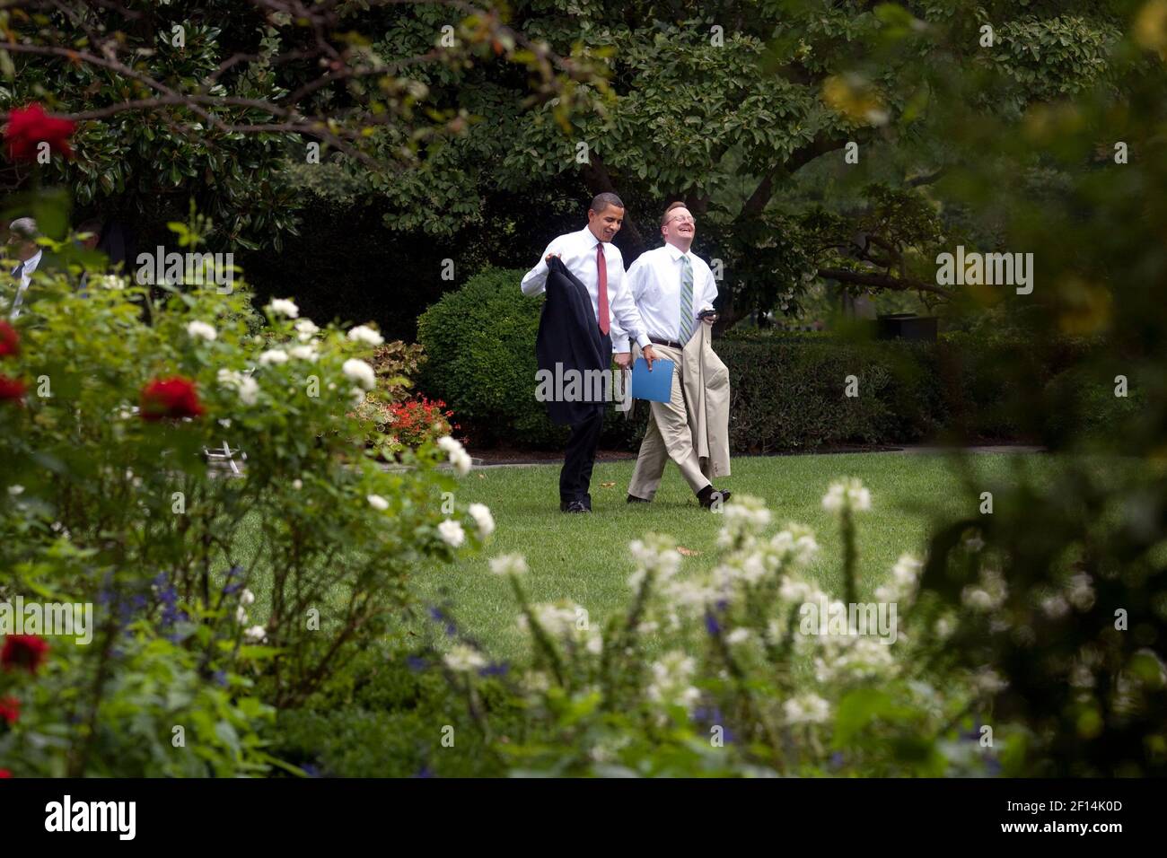 President Barack Obama and Press Secretary Robert Gibbs walk through the Rose Garden back to the Oval Office after the outdoor senior staff meeting on a pleasant summer day in Washington  August 12 2009. Stock Photo